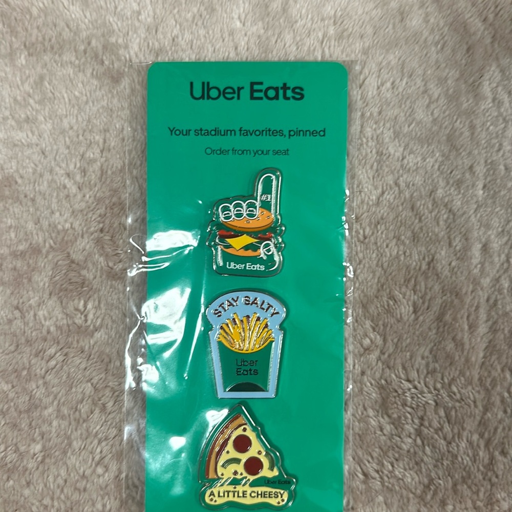 Uber eats stadium pins, three pins, Uber eats, stay salty, a little cheesy New